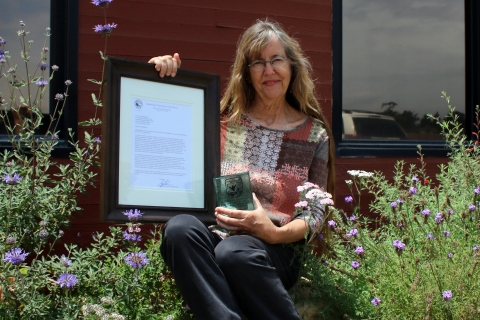 A woman holding an award