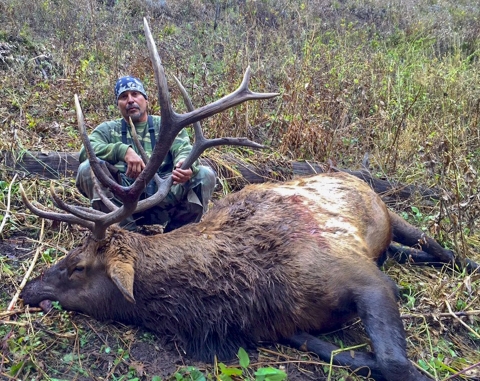 A man posing with a hunted animal
