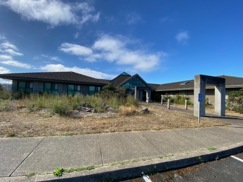 Oregon Coast National Wildlife Refuge Complex Office before a blue sky with sparse clouds