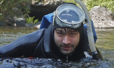 a man in water wearing snorkeling gear