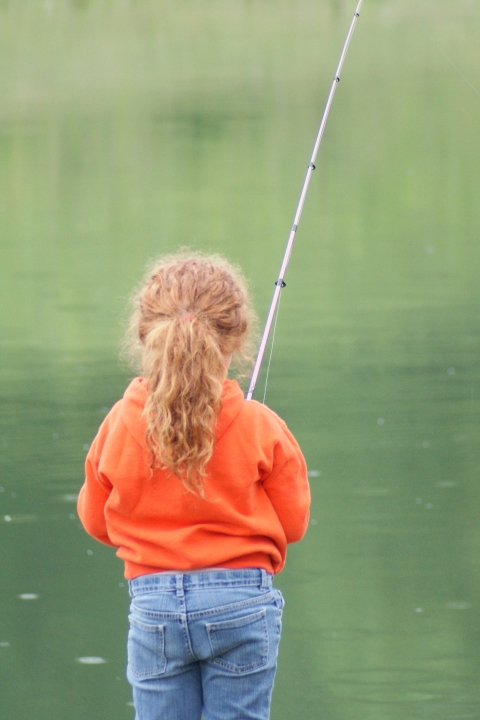 A small child fishing.