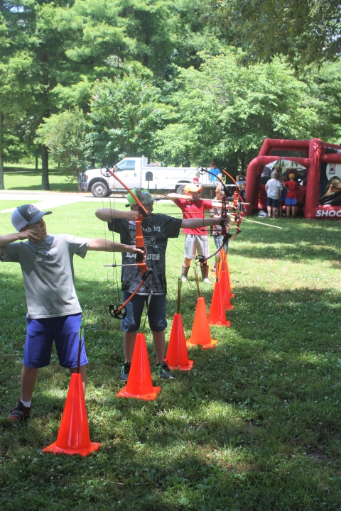 Children shooting bows and arrows.