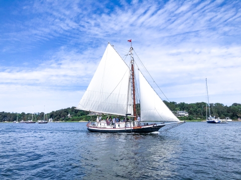 18th century model schooner sails across the bay