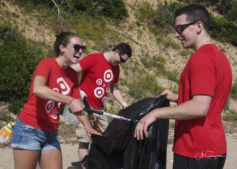 Volunteers having fun while picking up trash on beach