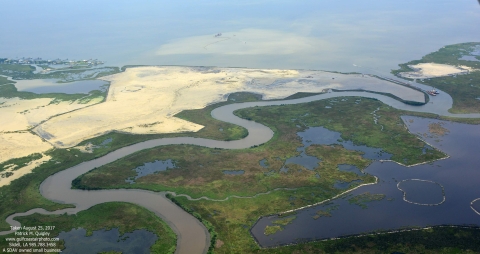 Aerial view of Bayou Bonfouca with areas of sandy sediment filling in areas next to bayou that had eroded