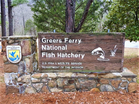 Stone and wood entrance sign at Greers Ferry National Fish Hatchery