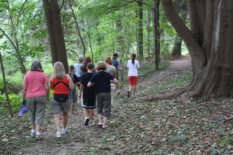 Group of visitors walk down a refuge trail 