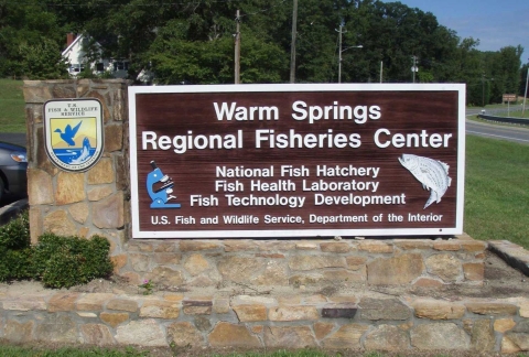 The Fish Technology Center brown and white entrance sign welcomes visitors to the facility.