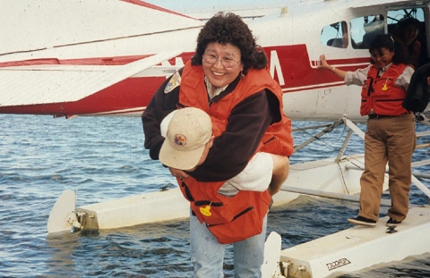 woman given assistance getting off a float plane