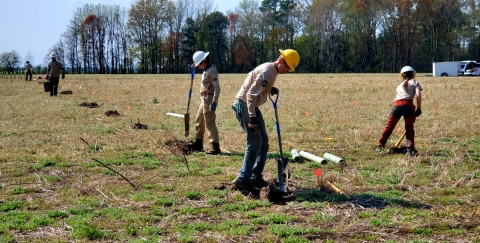 Conservation Crew digging in field