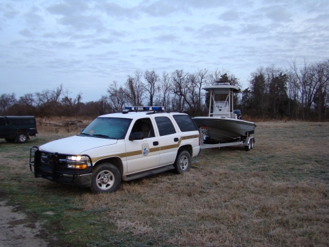 Boat hitched to law enforcement vehicle 