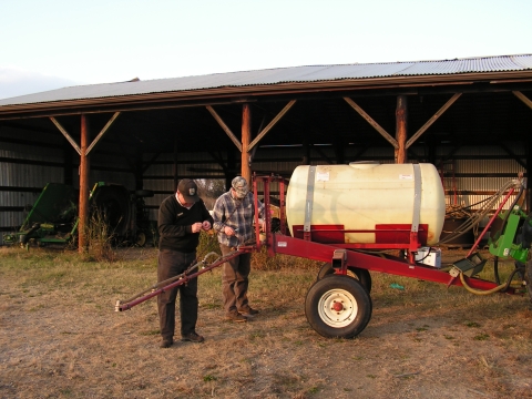 Maintenance staff working on a sprayer