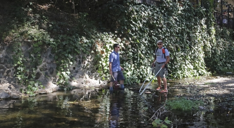 two men standing in a river