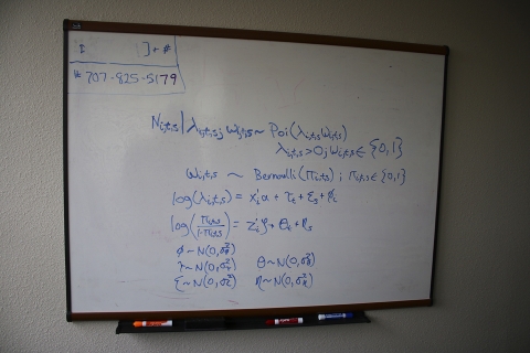 A whiteboard with math on it