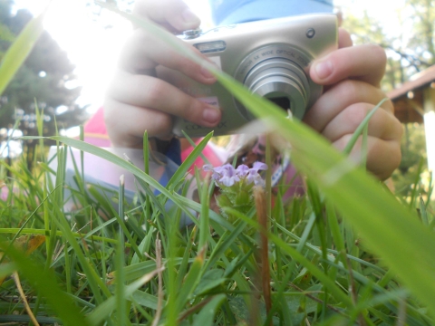 Child taking close up picture with camera