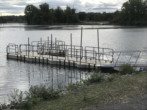 Accessible floating fishing dock with metal railings at Ringneck Marsh