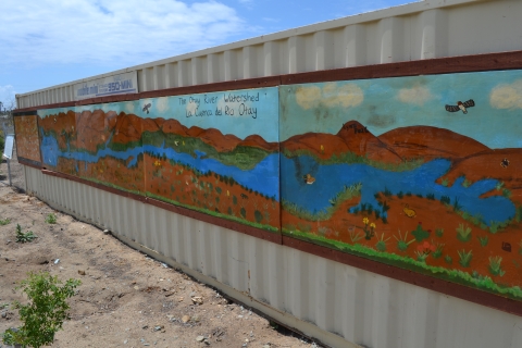 Mural on the side of shipper container depicting the Otay River watershed.