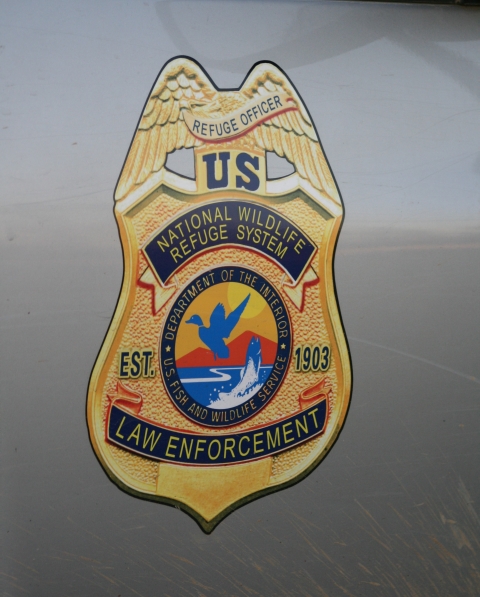 A large Law Enforcement sticker on the side of a truck.