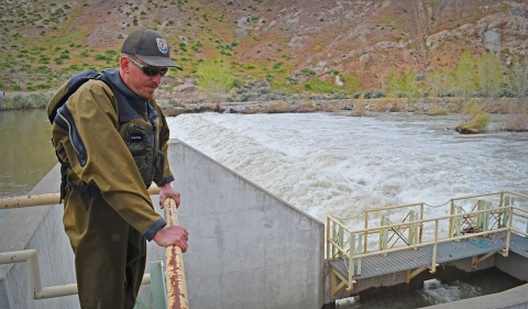 a man standing next to a river