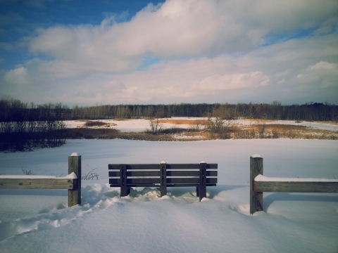 Image of bench overlooking a snowy landscape