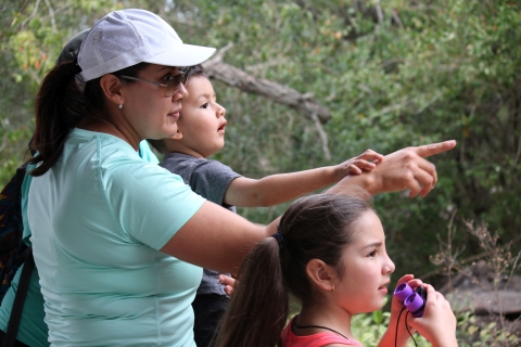 A woman and her two young children look at birds at Laguna Atascosa National Wildlife Refuge in Texas.