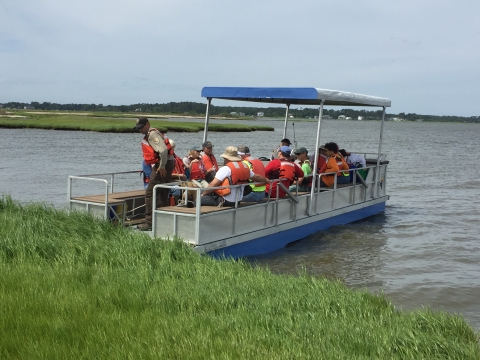 Volunteers arriving to island on pontoon boat