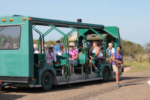 Visitors disembark from a green tour tram at Laguna Atascosa National Wildlife Refuge in Texas.