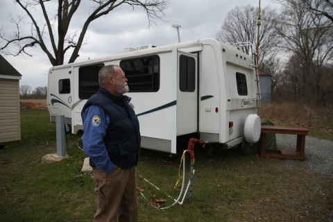 Volunteer in front of trailer pad