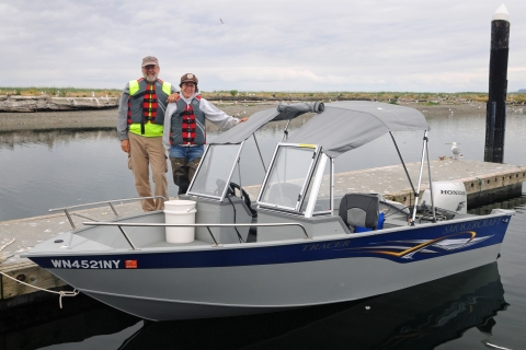 The Robinsons Stand Next to Their Boat at the Dock