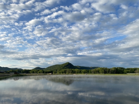 Looking at a hatchery pond and bluffs on a beautiful cloudy day