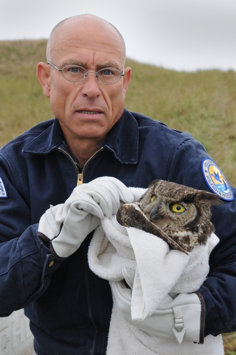 Refuge Volunteer Peter Davis Carries an Injured Great Horned Owl