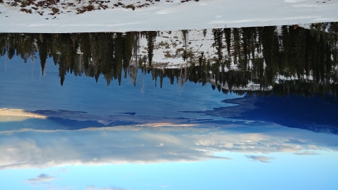 A snowy Scene with a lake in the background