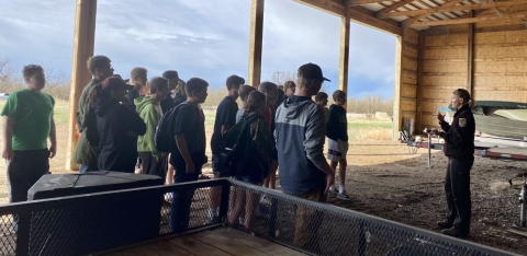 Wildlife Biologist Jessica Larsen talks to a group of 8th grade visitors