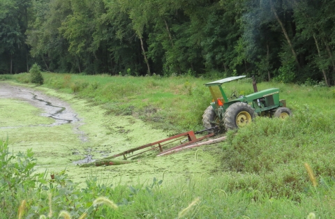 Tractor-driven pump working in moist soil unit