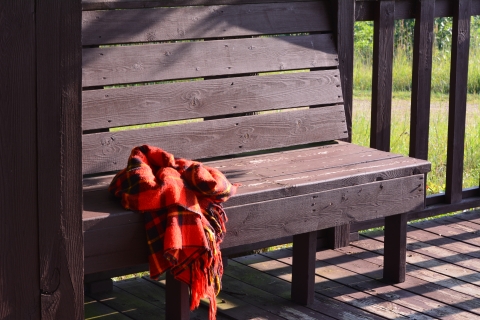 Red blanket on observation deck bench