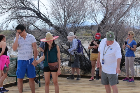 People on boardwalk, volunteer pointing 