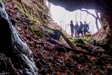 Four biologists standing at the opening of a mine