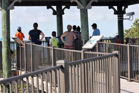An image of visitors looing off a observation deck.
