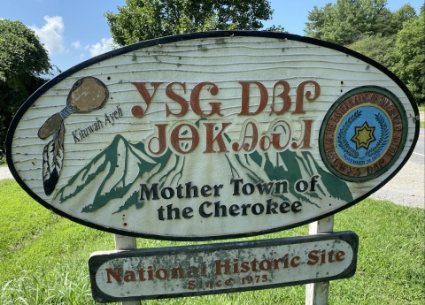 A rustic sign that reads: Mother Town of the Cherokee.
