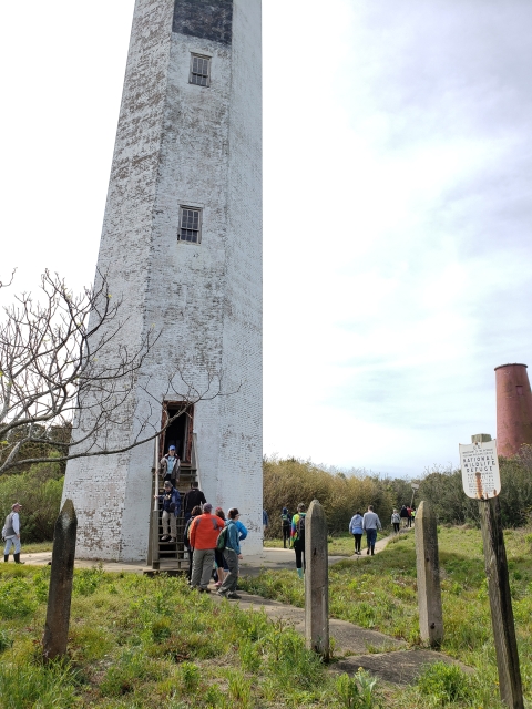 Participants stand in line to enter the 1857 lighthouse during the Lighthouse tour on Lighthouse Island, Cape Romain NWR