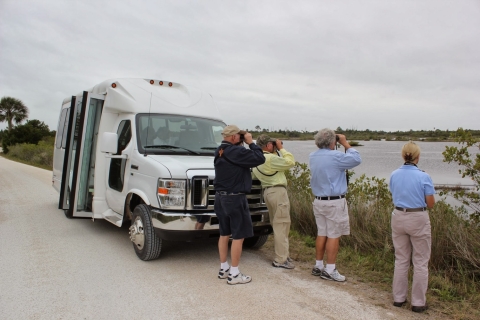 A bus with birders tours Black Point Wildlife Drive, Merritt Island National Wildlife Refuge