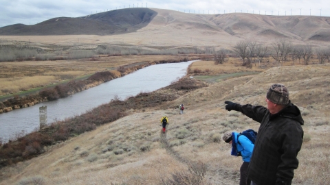 hikers walking on trail above the Walla Walla River.