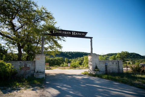 A wooden sign reads "Doeskin Ranch" over a driveway