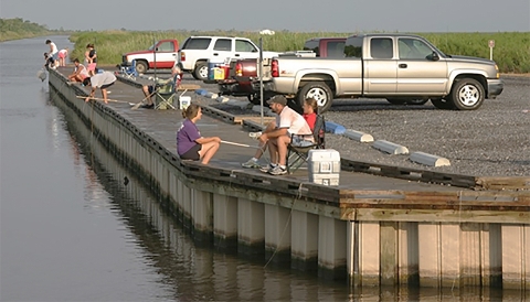 People sitting and Fishing from walkway
