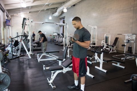man standing in room full of exercise equipment
