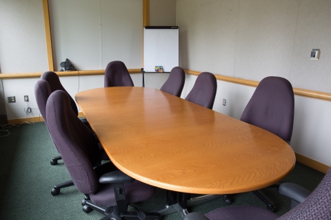 large oval table in conference room with chairs