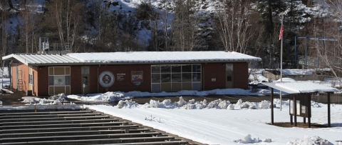 Hatchery building and welcome kiosk on a snowy day