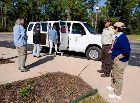 Visitors loading into refuge vehicle for a guided crane tour