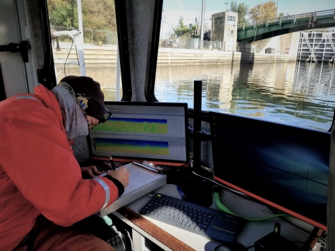 USFWS staff reordering data during a hydroacoustics sonar survey in the upper Illinois Waterway. 