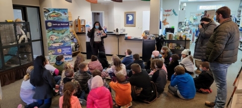 Environmental Education/Outreach Specialist Marsha Hart talks to a school group about the life cycle of a trout. 